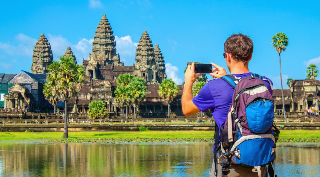 Projects Abroad volunteer explores Cambodia during his free time. Traveller takes a photo of Angkor Wat during his travels through Cambodia.